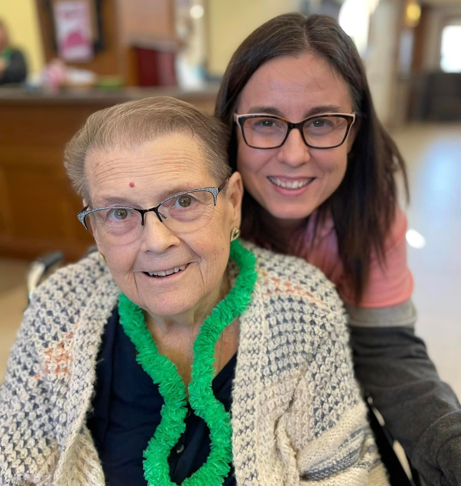Caretaker posing for a smile next to senior member