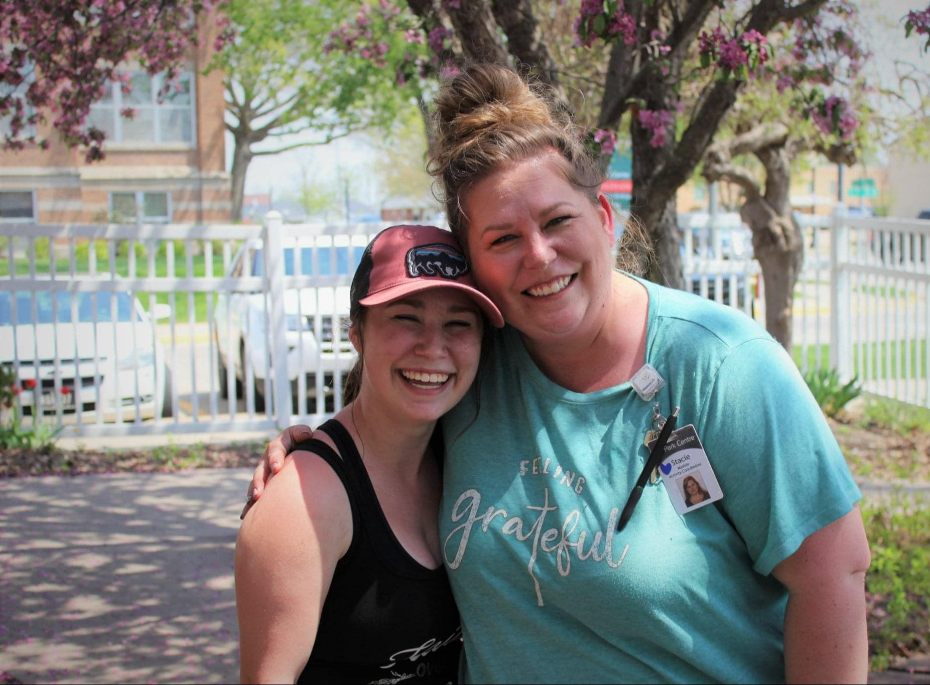 two female co-workers hugging and smiling