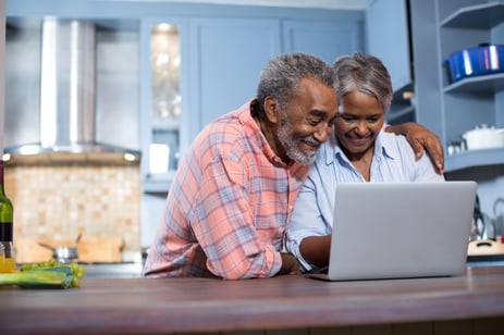 Woman and man looking at a laptop screen together