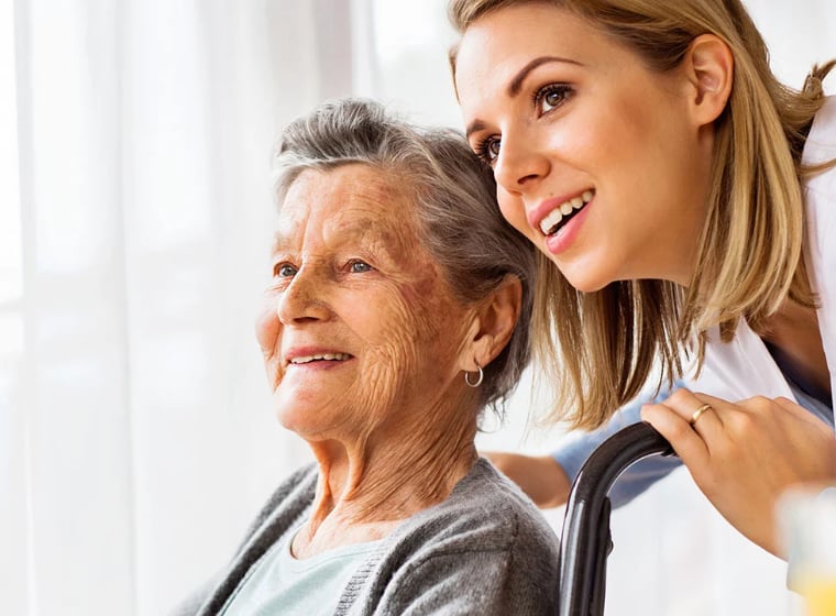 senior woman and caregiver gazing into the distance