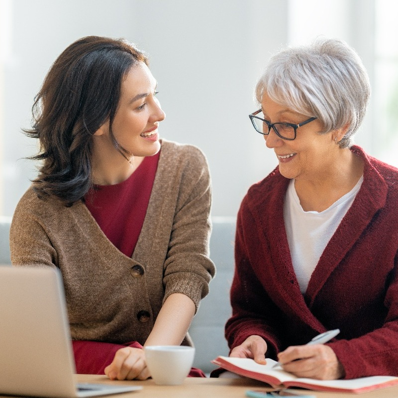 daughter and mother working on a laptop