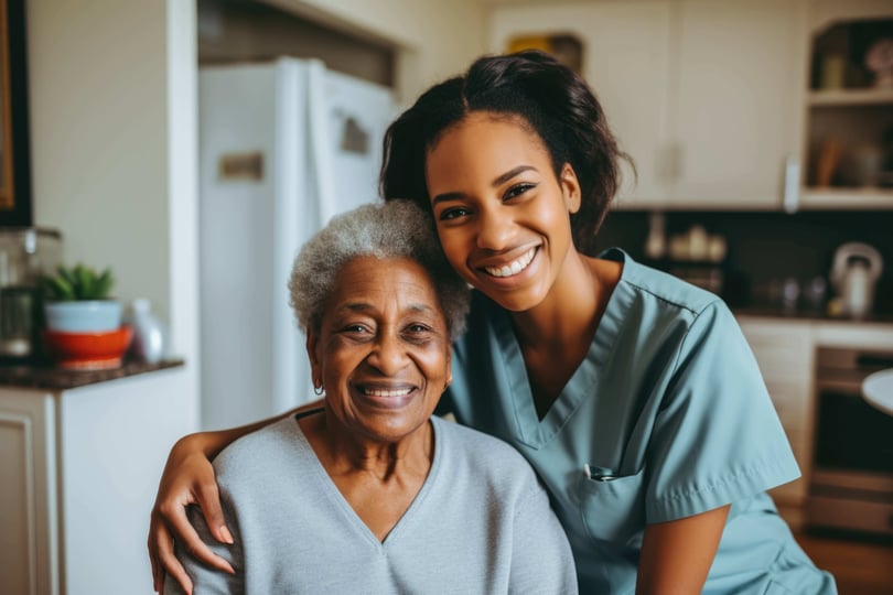 Portrait of a young female caregiver with senior patient at home