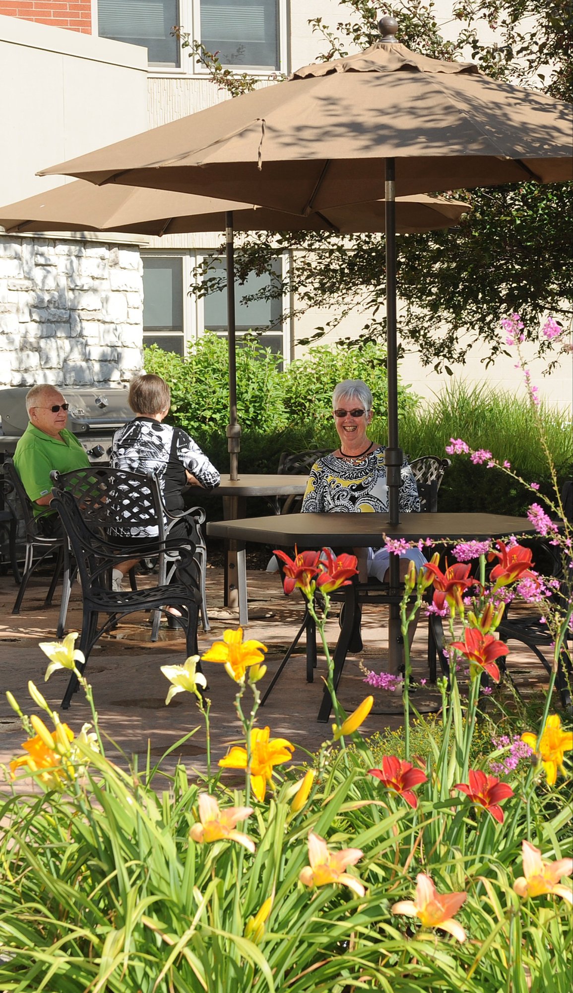 Ladies sitting at a table surrounded by flowers