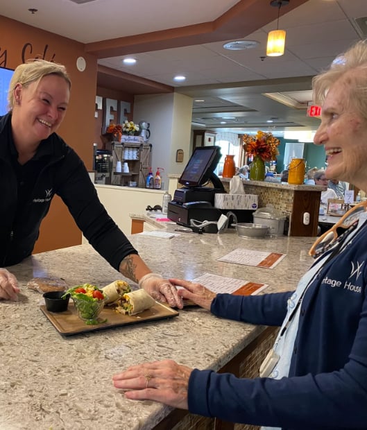 cook delivering food to a resident