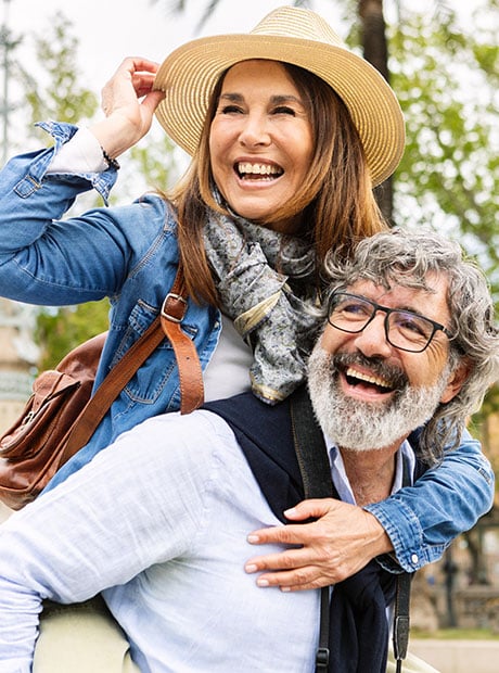 Senior couple laughing with each other outside