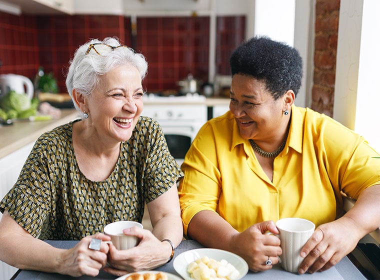 Two senior ladies drinking tea together