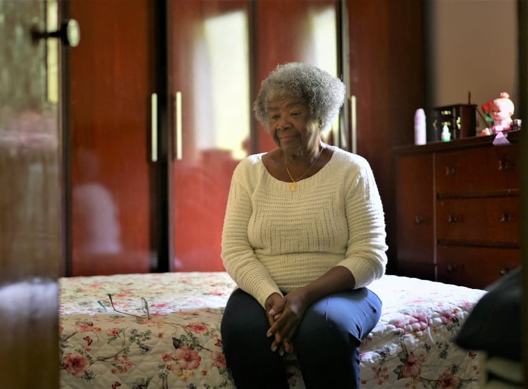 senior woman sitting on a bed