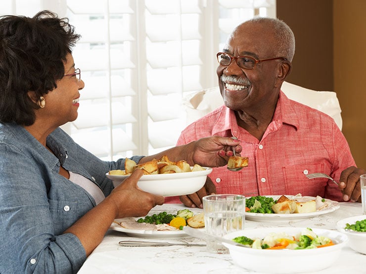 Senior Couple Enjoying Meal At Home