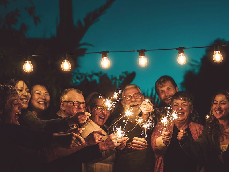 Senior friends with sparkles at night Senior friends with sparkles at night
