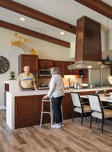 Senior friends hanging out in the community kitchen