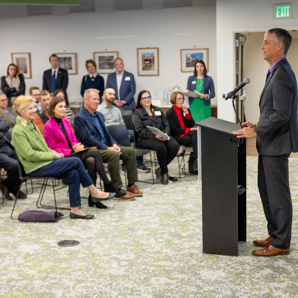 A group of people watching a presentation in Generations Hall