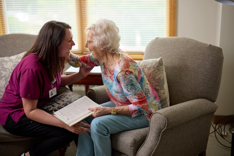 Senior woman and her caregiver in her home