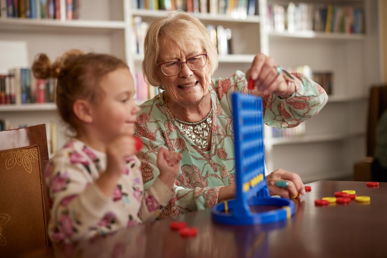 Grandmother and grandchild playing a game together