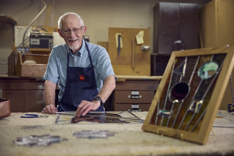 Older man working on his stained glass hobby
