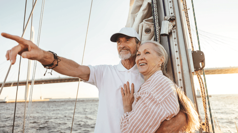 Senior couple sailing on water