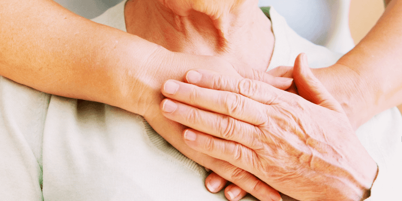 Mature female in elderly care community gets help from a hospital personnel nurse