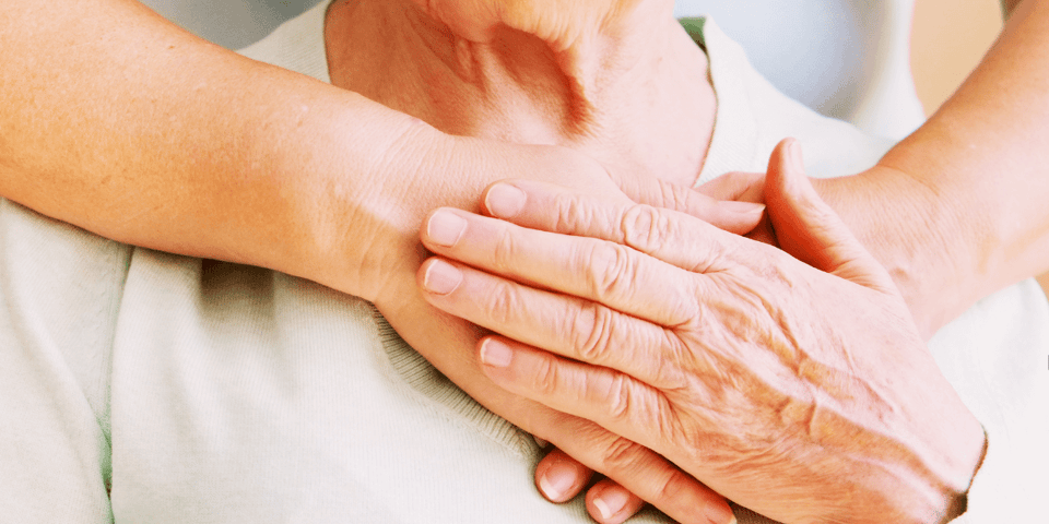 Mature female in elderly care community gets help from a hospital personnel nurse