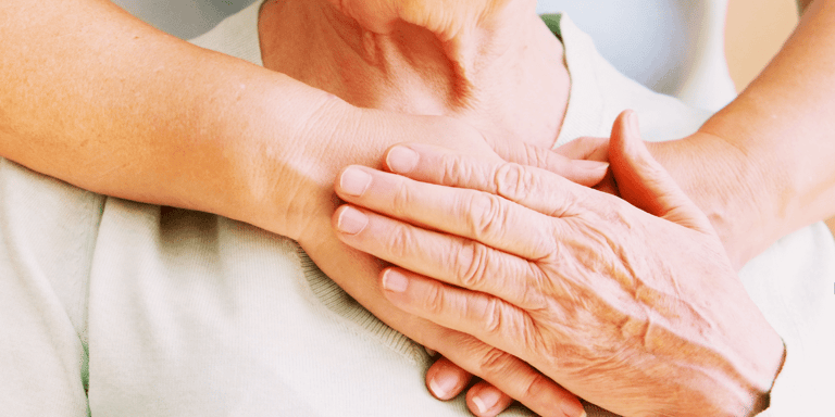 Mature female in elderly care community gets help from a hospital personnel nurse
