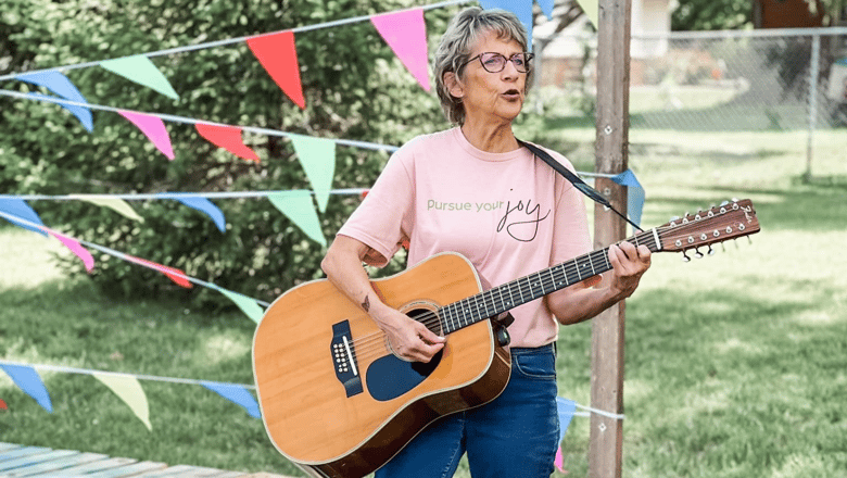 A guitarist playing a concert in a park