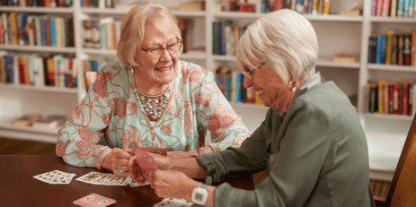 Two senior woman playing cards